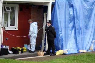 Police and forensic officers at the murder scene in Summersell House