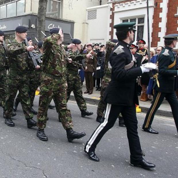 Members of the Territorial Army parade down Kensington High Street