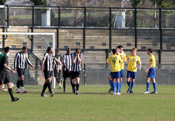 Heading down: Terrors captain Ronnie Fletcher holds his head in his hands as Concord celebrate another goal on Saturday