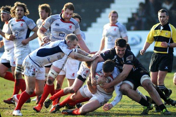 Sing so we're winning: Centre Charlie Hayter, pictured being halted by the Esher defence in February, has called on London Scottish's supporters to be the team's 16th man