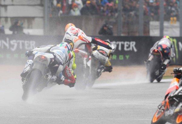 Slipping and sliding: Gino Rea, centre, struggles to keep his bike upright before a crash with Johann Zarco ended his first race at Le Mans. Picture: Graham Holt