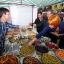 Kez Hassan (far left), Paul Collins (middle) - both from the Town Team, and Mary Portas try some olives on Surrey Street Market.