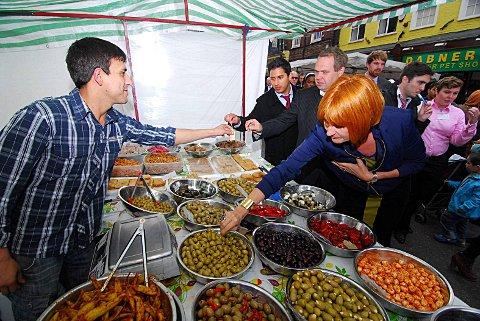 Kez Hassan (far left), Paul Collins (middle) - both from the Town Team, and Mary Portas try some olives on Surrey Street Market.