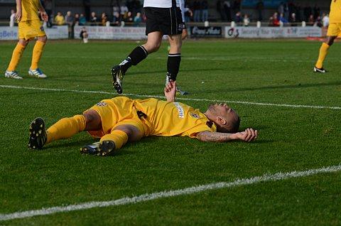 Down and out: Craig Watkins takes a quick breather in the FA Cup defeat to Bromley 		             SP68721