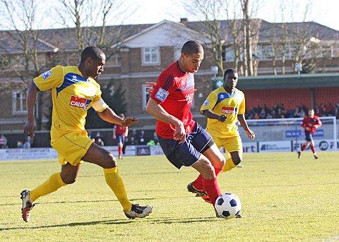 Back: Joel Ledgister in action for Hampton last season against one of his former clubs Woking