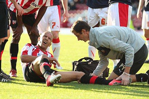 Stricken: Brentford's Farid El-Alagui receives treatment in Saturday's 2-1 win over Crawley Town