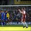 Not a good start: Cheltenham celebrate their second goal, which effectively sealed the Dons' fate     SP70799