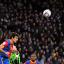 Mile Jedinak powers away a header against Brighton