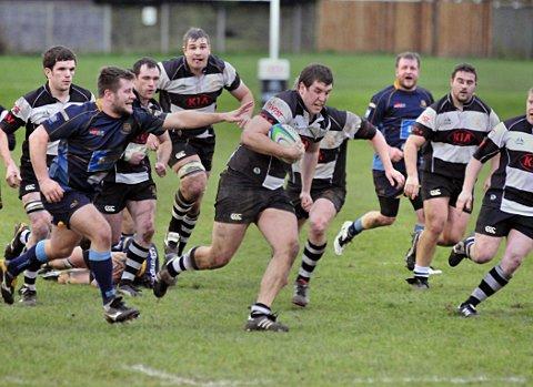 On the charge: Peter Matthews shows the team determination to get through the Guildford back line   SP72888