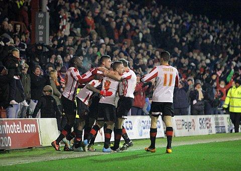 You beauty: Clayton Donaldson is mobbed by his team mates after hitting the winner on Tuesday