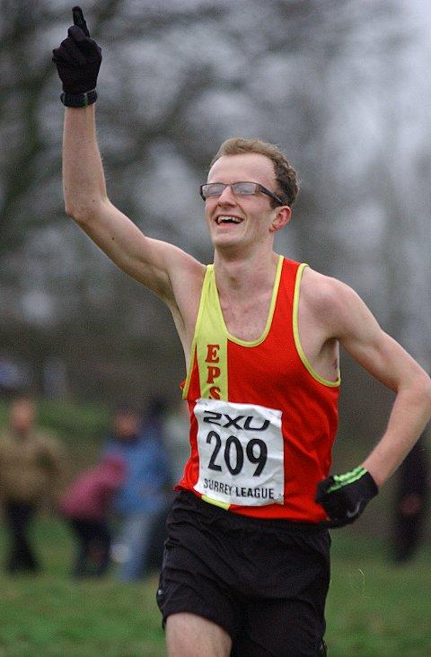 First man home: Ollie Garrod celebrates crossing the line first in the Surrey League Divsion Two meeting on Mitcham Common    SP73251