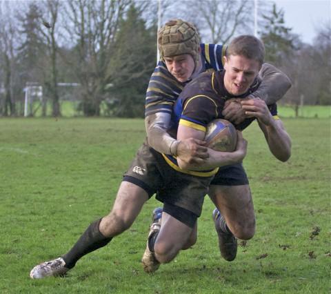 Pulled up short: Old Walcountians' Ross Norton is tackled just short of the white line Picture: Alun Stockton