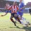 Tough day: Chelsea defender Gary Cahill clatters in to Brentford's Shaleum Logan in Sunday's 2-2 draw at Griffin Park