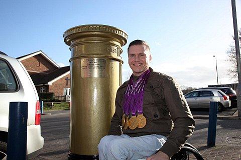 Golden glow: David Weir with post box commemorative plaque and four 2012 Paralympic gold medals