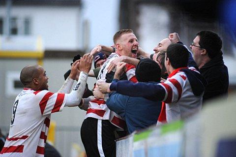Goal rush: Kingstonian midfielder Lewis Taylor celebrates with fans at Kingsmeadow