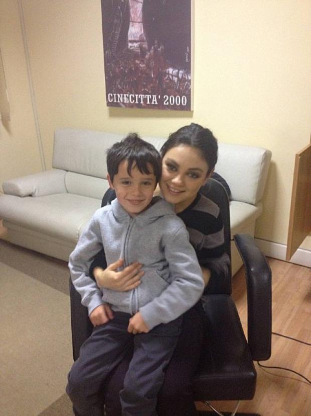 Oliver Crouch, a pupil at Kingswood House School in Epsom, with Hollywood star Mila Kunis