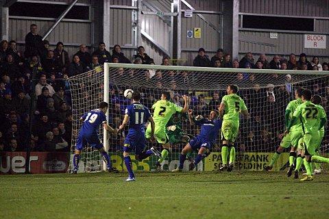 Off the mark: Dons skipper Alan Bennett stoops to head home his first goal for the club            SP73936