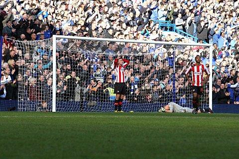 Sinking feeling: Bees defender Harlee Dean, goalkeeper Simon Moore and full back Shaleum Logan cannot hide their frustration after Oscar bundled in Chelsea's killer second goal on Sunday