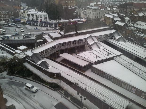 March madness: The rooftops of Sutton town centre were covered in white at lunchtime after snow and hail showers