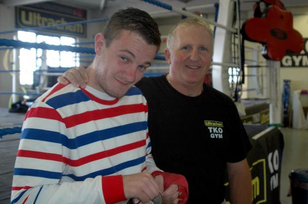 No holds barred: Danny Connor, here with coach Alec Wilkey, is out to down his best friend in the ring