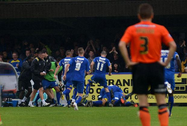 Winners: Goalscorer Chris Arthur is under that pile of AFC Wimbledon players.... somewhere SP73011