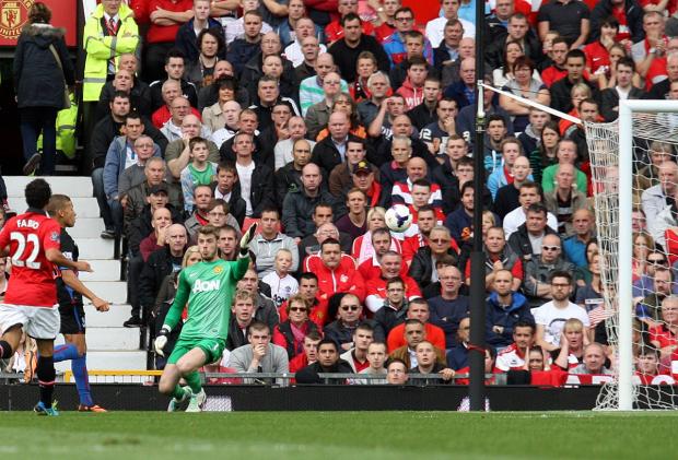 So close: Dwight Gayle lifts the ball past David de Gea at Old Trafford, unfortunately it dropped just the wrong side of the post SP79011