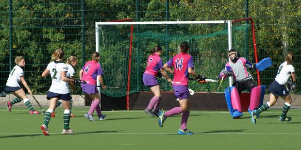 Precise finish: GB international Rebecca Herbert, far right, fires past England goalkeeper Becky Batsford to cap her Surbiton debut with a goal in Saturday’s 3-1 win at Sutton Coldfield. Picture: Stuart Amos