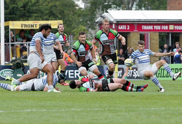 Taste of his own medicine: Quins centre Tom Casson drops the ball after being flattened by the Saracens defence