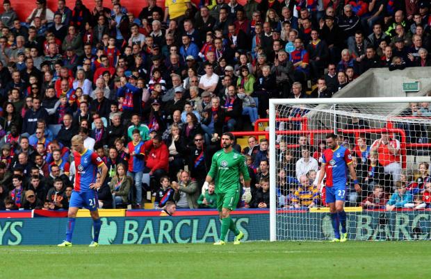 Nail in the coffin: Palace are dejected after Olivier Giroud's last-gasp header made it 2-0 to Arsenal