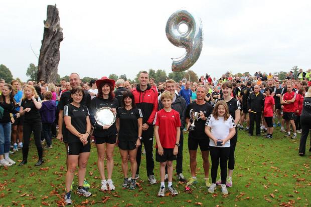 Streatham Guardian: Winner: Kingston's Phillip Bearman, third from right, with his 2013 top male points scorer trophy awarded on the ninth anniversary of the Bushy Park parkrun Streatham Guardian: Winner: Kingston's Phillip Bearman, third from right, with his 2013 top male points scorer trophy awarded on the ninth anniversary of the Bushy Park parkrun