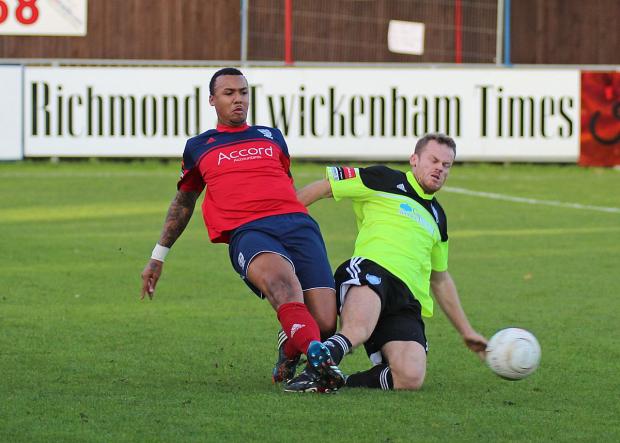 Streatham Guardian: On his way: Hampton and Richmond Borough's Marcus Rose nips in to dispossess Met Police striker Allan Tait, right Streatham Guardian: On his way: Hampton and Richmond Borough's Marcus Rose nips in to dispossess Met Police striker Allan Tait, right