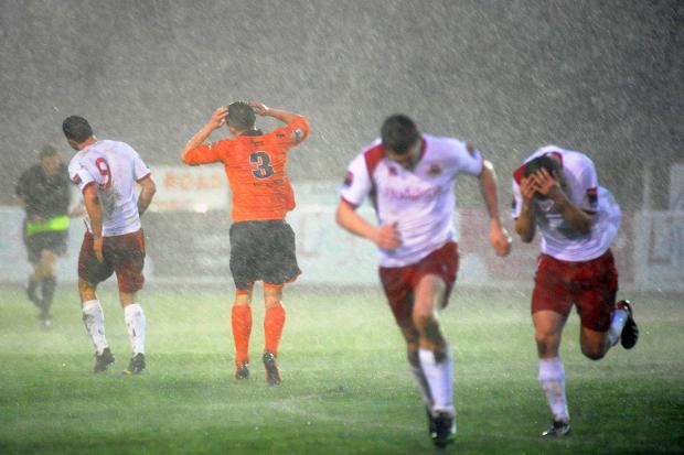 Streatham Guardian: Run for it: Whitstable Town players run for cover during the storm that forced the abandonment of Saturday's game Streatham Guardian: Run for it: Whitstable Town players run for cover during the storm that forced the abandonment of Saturday's game