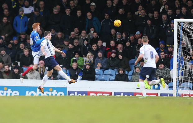Streatham Guardian: One chance, one goal: Portsmouth’s Ryan Taylor rises highest to score the decisive goal at Fratton Park, sending Dons home with nothing except a third consecutive League Two defeat Picture: Joe Peppler Streatham Guardian: One chance, one goal: Portsmouth’s Ryan Taylor rises highest to score the decisive goal at Fratton Park, sending Dons home with nothing except a third consecutive League Two defeat Picture: Joe Peppler